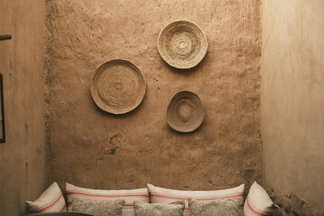 Rustic wall decor with woven baskets above comfortable cushions